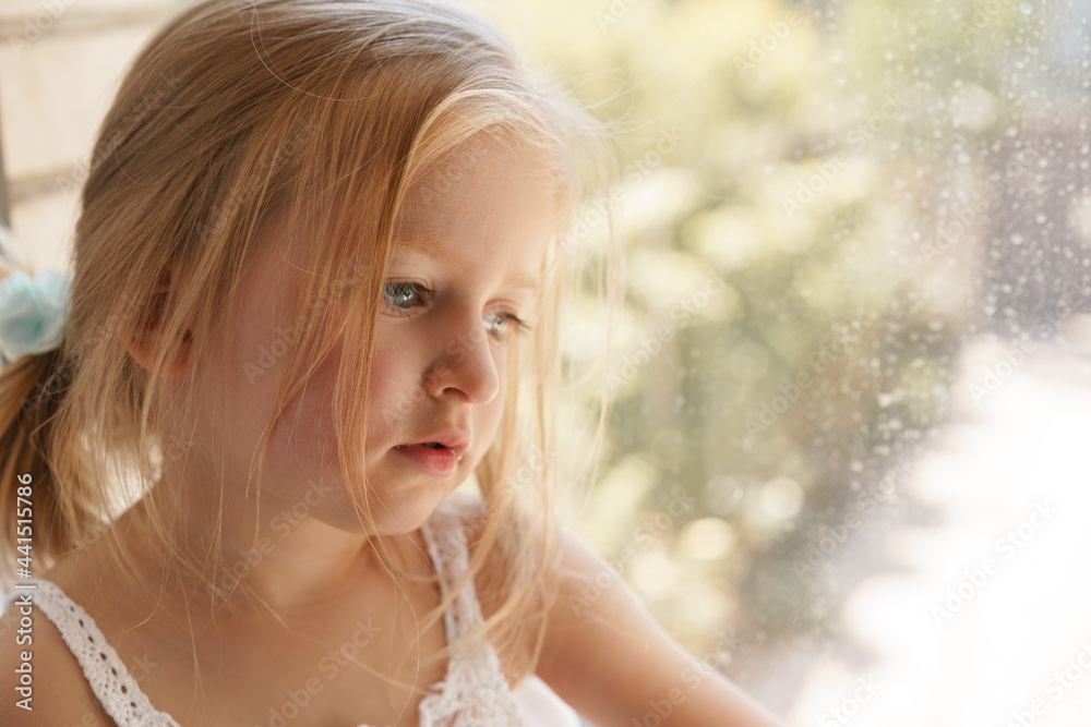 Close up portrait of a little blonde girl on a summer day Close up portrait of a little blonde girl on a summer day