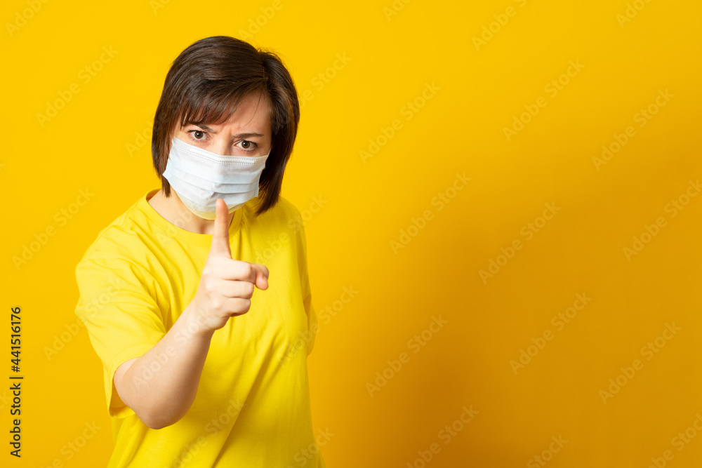 Outraged young woman points a finger feels very angry expresses