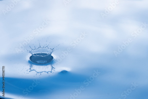 Water drop splash with reflection.