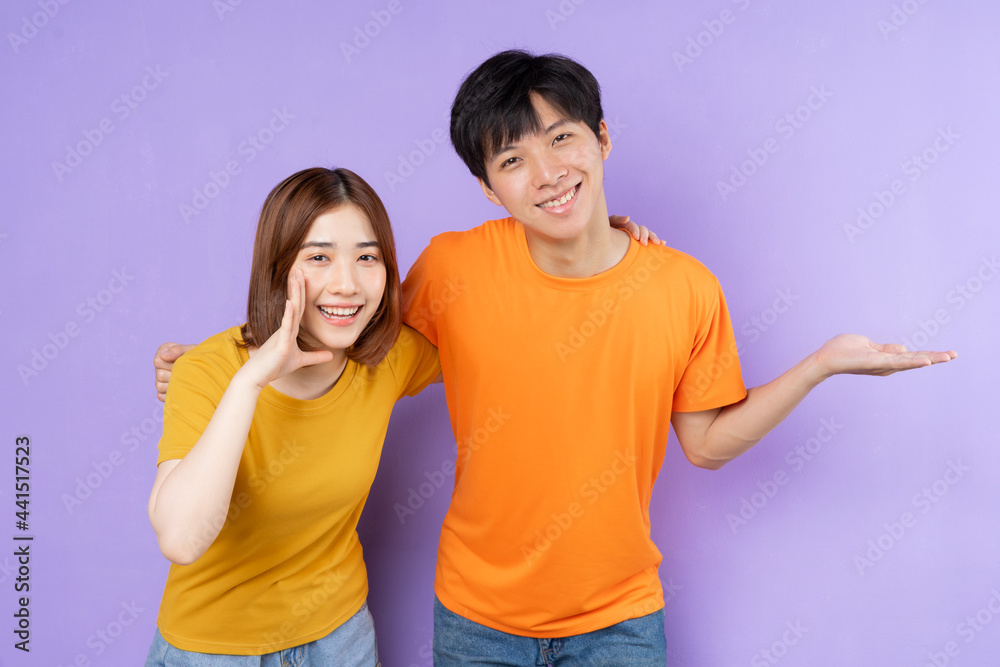 Asian couple portrait, isolated on purple background Asian couple portrait, isolated on purple background