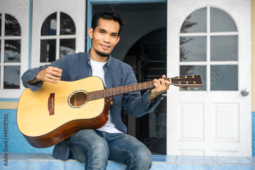 Man playing guitar happy leisure at home