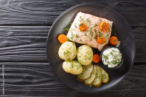 Swedish traditional cold poached salmon kall inkokt lax with new potatoes closeup in the plate on the table. horizontal top view from above