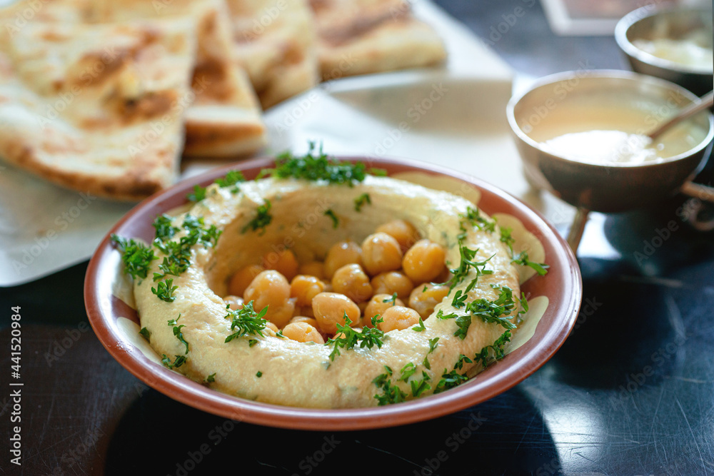Lebanese appetizers of hummus with chickpea dip, pita bread on background, Middle eastern food