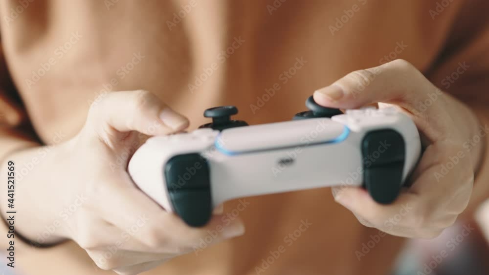 Hands presses buttons on game joystick and play TV game. Hands presses buttons on game joystick and play TV game.