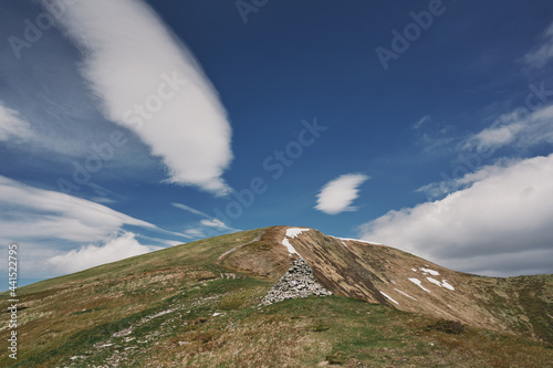 Snow in the mountains in summer. Sunny day in the mountains. Ukrainian Carpathian mountains.