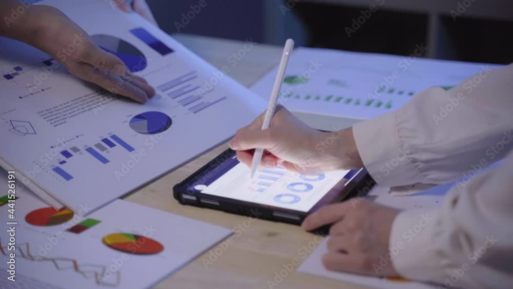 Close up hand of businesspeople brainstorming and briefing idea with graph for marketing and invest of finance at business meeting with colleague in boardroom Close up hand of businesspeople brainstorming and briefing idea with graph for marketing and invest of finance at business meeting with colleague in boardroom