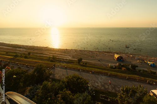RUSSIA, YEYSK - AUGUST 20, 2016: View of the Sea of Azov and the small tourist town of Yeysk from above of the Ferris wheel at sunset. Russia, Sea of Azov, Krasnodar Territory, Yeysk.