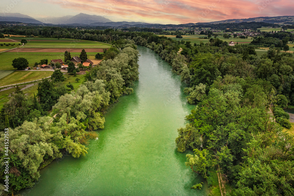 aerial view of a green riveri n sunset 