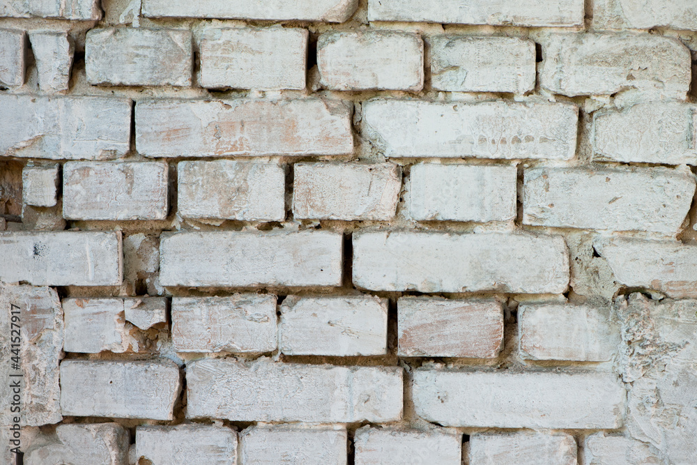 Abstract old white brick wall. background facade brick wall black and white. Vintage old brick wall texture. Grunge stone wall horizontal background. Dilapidated building facade with damaged plaster.