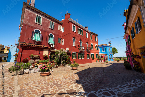 Old houses with bright colors (multi colored ) in Burano island in a sunny spring day with clear sky. Venetian lagoon, Venice, UNESCO world heritage site, Veneto, Italy, southern Europe. © Alberto Masnovo
