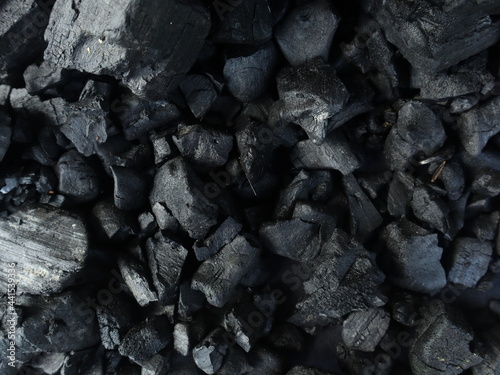 Dark coal texture, the remnants of wood burning into charcoal that can be used for barbecue