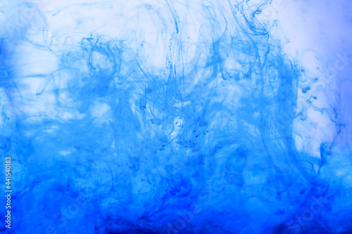 Cobalt blue and aquamarine colors mix. Acrylic Painting. Paint movement macro. Glitter ink flow. Glitter fluid motion. Moving flowing stream of liquid paint. Decorative abstract art background