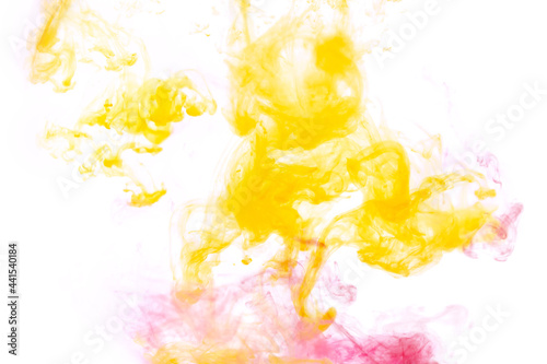 Bright pink and yellow acrylic paint swirling in water. Ink moving in liquid creating abstract clouds. Traces of colorful dissolving in water, changing shape. Abstract decorative creative background.