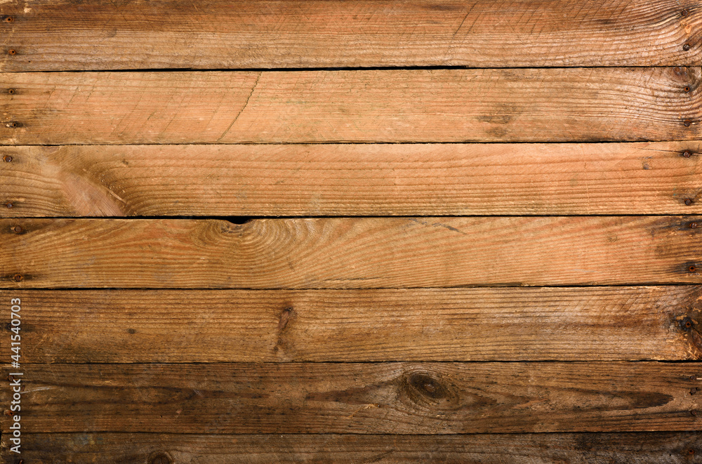 Fototapeta premium Weathrered old wooden planks background with nails top view.
