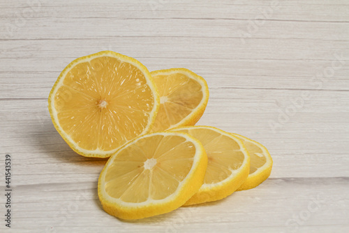 Pile of fresh lemon slices on wooden desk