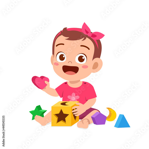 cute little baby girl playing with colorful puzzle