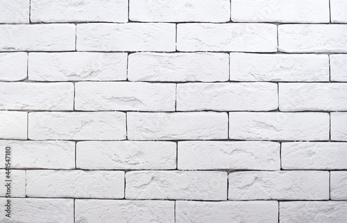 Brick wall is painted with white paint. Abstract texture for background.