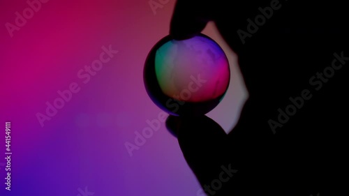 Hand control clear neon light globe ball control technonogy to help or destroy planet photo