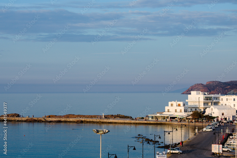Naxos island Greece. Harbor landscape with high level view over the bay and causeway to the old town.  Blue sky and copy space. Landscape aspect.