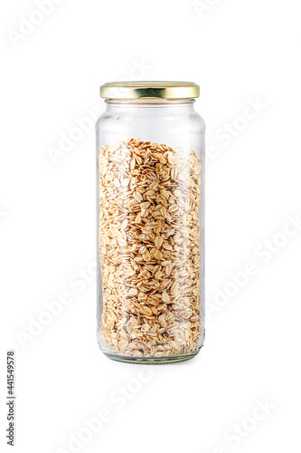 Jar filled with Rolled Oats. Oats in glass jar isolated on white background. Dry, uncooked flakes