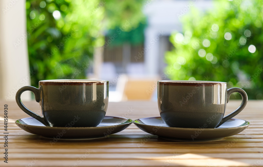 Two cups of hot coffee on wooden table close up. Two cups of hot coffee on wooden table close up.