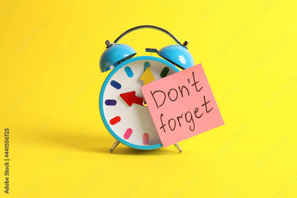 Alarm clock and reminder note with phrase Don't forget on yellow background  Photos | Adobe Stock