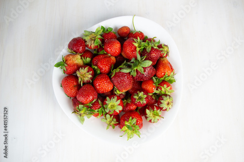 fresh strawberries in a bowl on white background