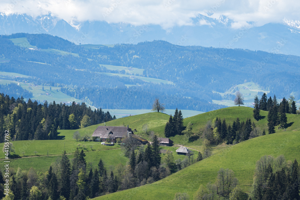 classical Emmental farm hous in the hills on a spring day