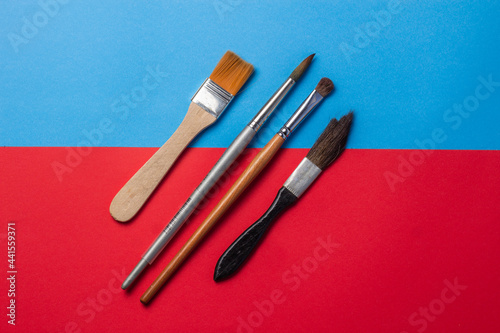 Assorted brushes on colored background