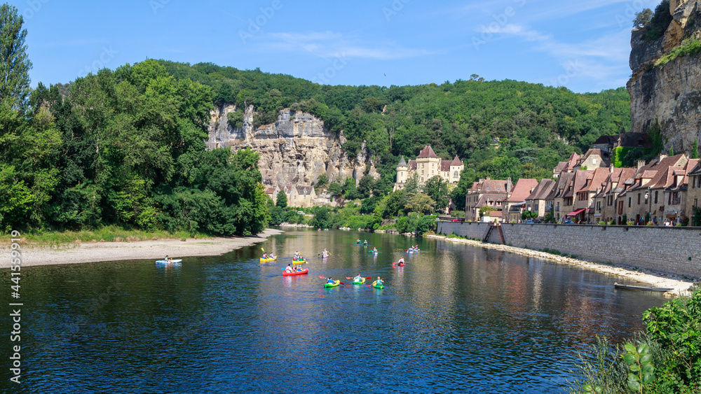 Canoeing on the Dordogne River in the village La Roque Gageac, one of France's most beautiful villages, Malartrie Castle in the background. 
