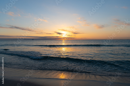 amazing seascape with cloudy sky over sea sunrise water with ships on horizon, sunset or sunrise.