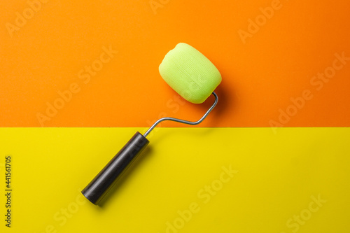 paint roller on orange and yellow background