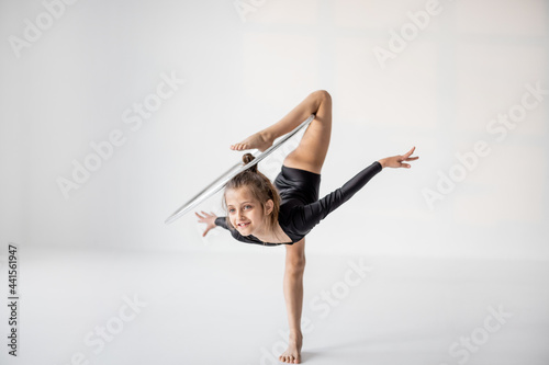 Photography Little girl practising rhythmic gymnastic with a ring at white room