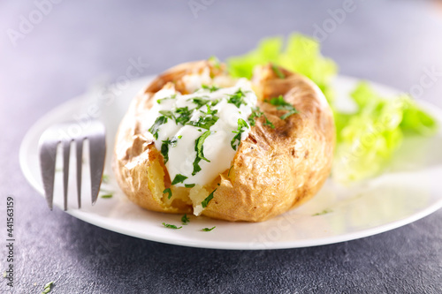 baked potato with cream and herbs