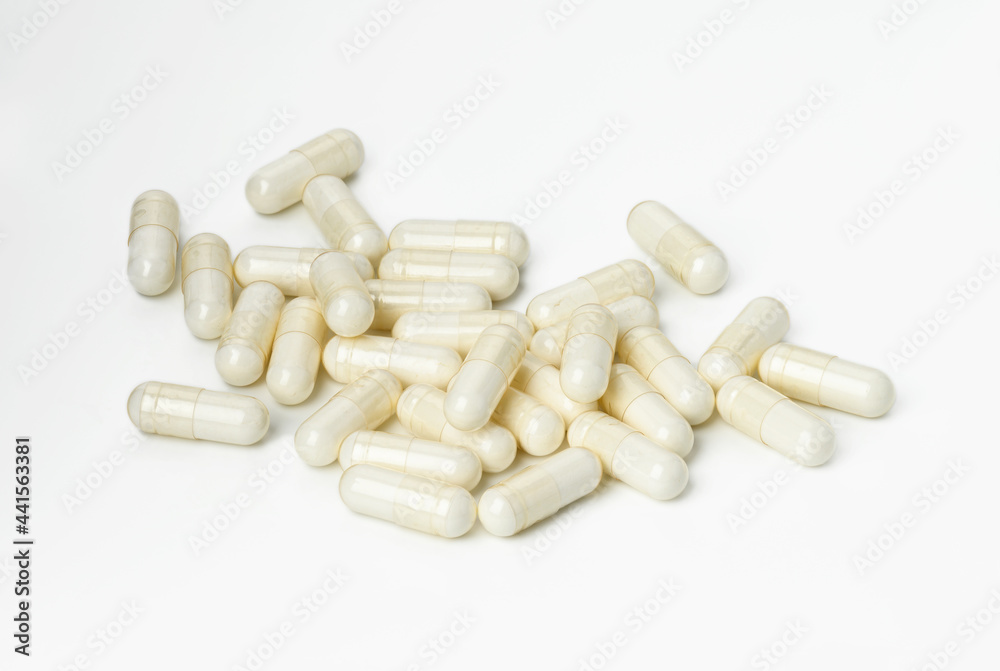 medical powder in white capsules on a white background. Treatment pills