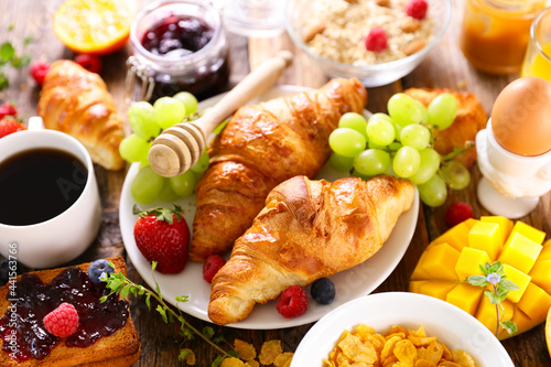breakfast with coffee, croissant and fresh fruits