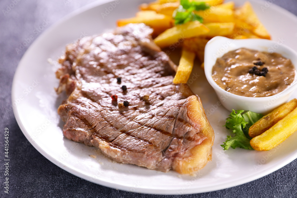 grilled beef steak with french fries and pepper sauce grilled beef steak with french fries and pepper sauce