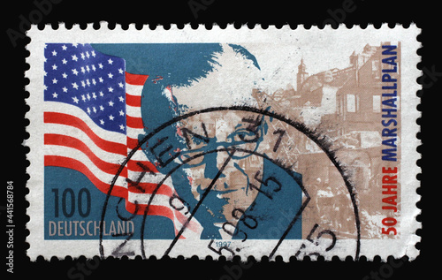 A stamp printed in Germany shows United States flag, George Marshall and bomb site, 50th Anniversary of the Marshall Plan, circa 1997
