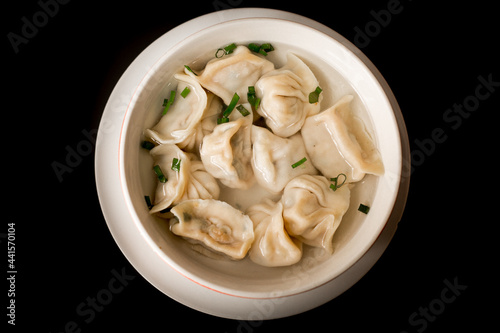 Soup with dumplings and scallion photo