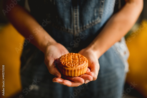 Crop woman with mooncake photo
