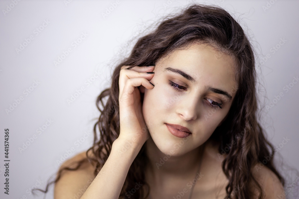 Portrait of a teen brunette girl daydreaming Portrait of a teen brunette girl daydreaming