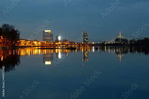 Night view of the city Riga, Latvia. Blue night photo to the city of Riga when building reflecting in the water of Daugava river.