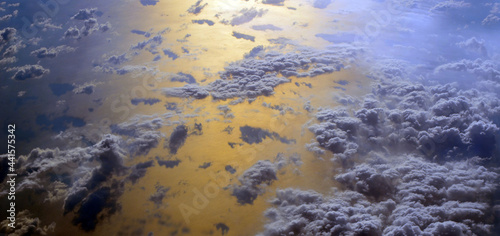 Aerial view of clouds and sky. Bird eye view from airplane window. Clouds panorama from airplane.