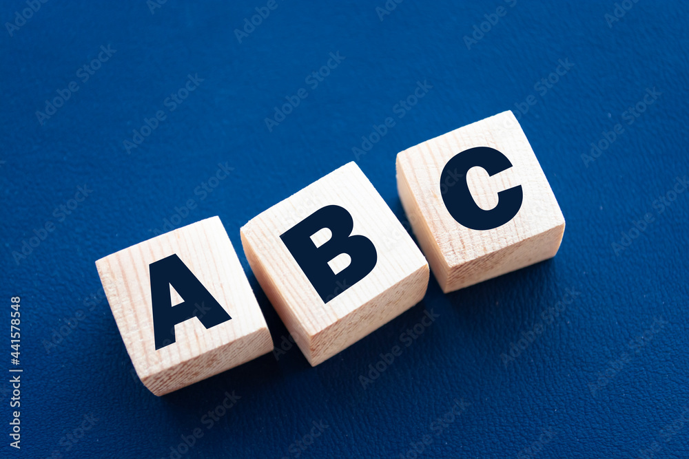 ABC letters wooden blocks on blue background. Education concept ABC letters wooden blocks on blue background. Education concept