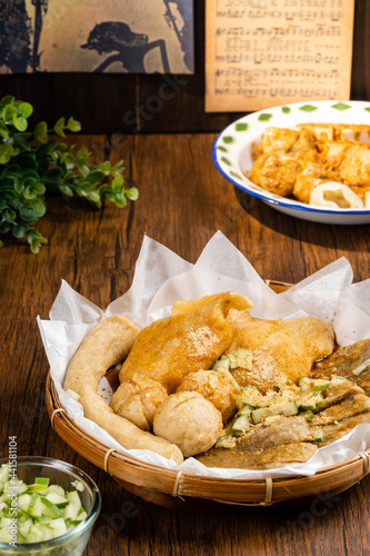 Pempek or empek-empek is a savoury Indonesian fishcake delicacy, made of fish and tapioca, from Palembang South Sumatera, Indonesia. Pempek is served with rich sweet and sour sauce called kuah cuko photo