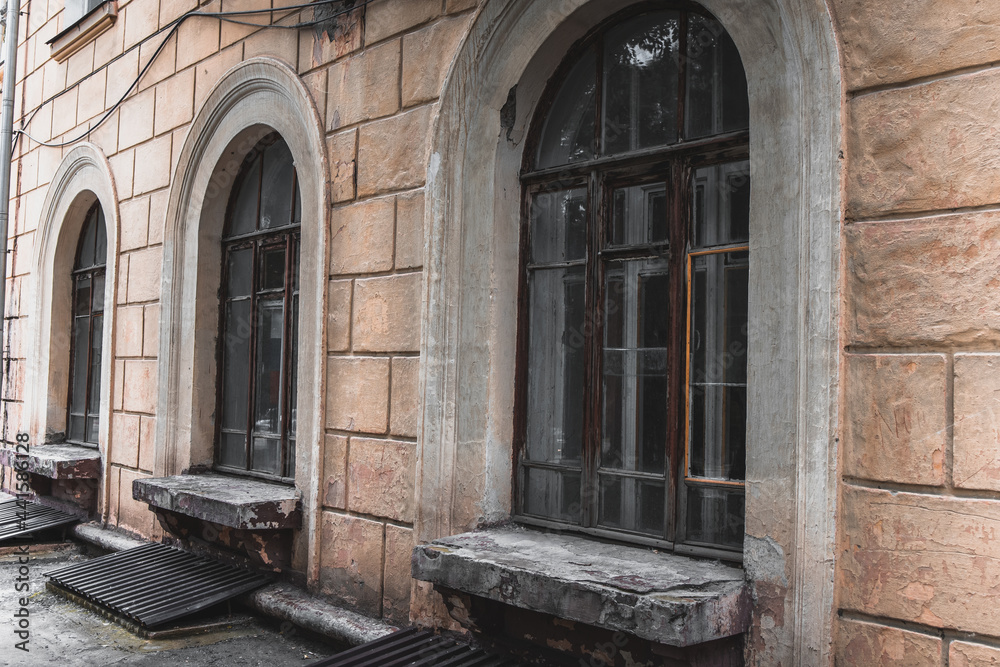 Fototapeta premium An old house with large windows in a wooden frame