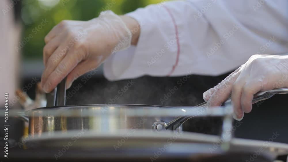 The chef prepares walleye fillets on the terrace of the summer restaurant. Show kitchen for restaurant guests. The chef prepares walleye fillets on the terrace of the summer restaurant. Show kitchen for restaurant guests.