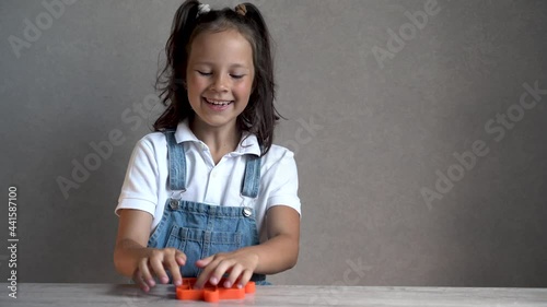 the child plays pop it and is happy