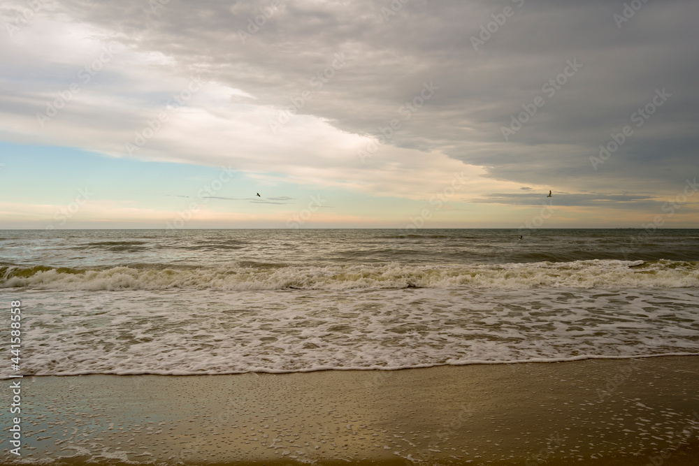 waves to the sea with the sky hanging over it with clouds