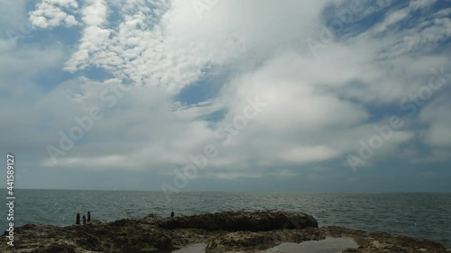 Wallpaper Mural Spring turquoise sea filmed in time laps. Small waves splash against the concrete breakwater on the shore. Light clouds float quickly across the blue sky. Calm seascape. Torontodigital.ca